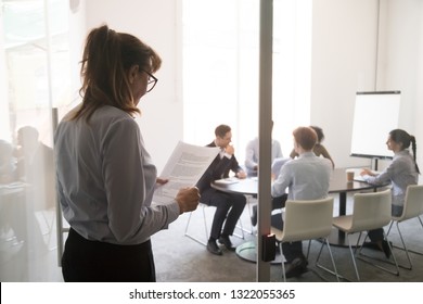 Stressed nervous stuttering inexperienced businesswoman standing at office door feeling afraid worried before performance reading paper preparing business speech, public speaking fear anxiety concept