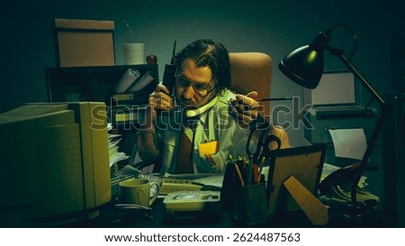 Stressed office worker multitasks with phone, pencil, paperwork in cluttered retro office, showing chaos, pressure, overwork, frustration. Concept of burnout, corporate absurdity, overload collapse