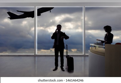 Stressed Out Businessman Passenger Arguing With A Flight Attendant Or Receptionist At An Airport Check In Counter.  He Is Angry Because Of A Delayed Or Cancelled Flight.  