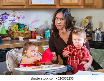 Stressed Out Mother In Kitchen With Her Babies