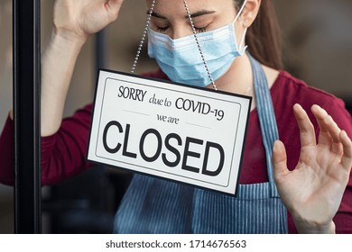Stressed owner forced to close the restaurant permanently due to restrictions on the coronavirus. Depressed businesswoman closing her business activity due to covid-19. Small business bankrupt.