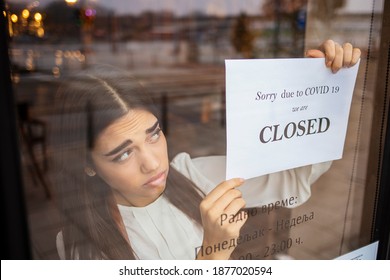 Stressed owner forced to close the restaurant permanently due to restrictions on the coronavirus. Depressed businesswoman closing her business activity due to covid-19. Small business bankrupt. - Shutterstock ID 1877020594