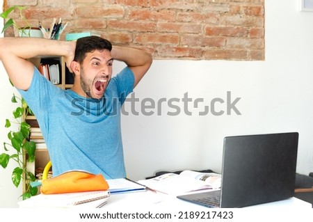 stressed and panicked man in front of the computer. student screaming at not finding his job. businessman panicking at the numbers of his small business. young man receives bad news.