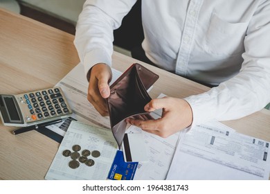 Stressed, Problem business person man, male holding and open an empty wallet not have money, credit card, not to payment bill, loan or expense in pay. Bankruptcy, bankrupt and debt financial concept. - Shutterstock ID 1964381743