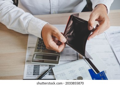 Stressed, Problem business person man, male holding and open an empty wallet not have money, credit card, not to payment bill, loan or expense in pay. Bankruptcy, bankrupt and debt financial concept. - Shutterstock ID 2033855870