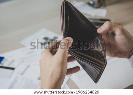 Stressed, Problem business person man, male holding and open an empty wallet not have money, credit card, not to payment bill, loan or expense in pay. Bankruptcy, bankrupt and debt financial concept.