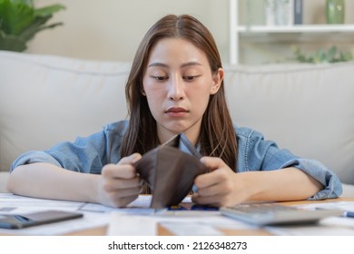 Stressed, Problem business person woman holding and open empty wallet, purse no have money for bill payment, credit card loan or expense. Bankruptcy, bankrupt or debt financial, mortgage concept. - Shutterstock ID 2126348273