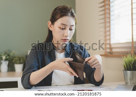 Stressed, Problem people asian woman, girl holding and open an empty wallet not have money, credit card, not to payment bill, loan or expense in pay. Bankruptcy, bankrupt and debt financial concept.