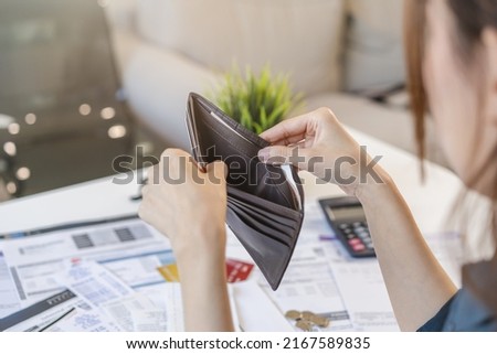 Stressed, Problem people asian woman, girl holding and open an empty wallet not have money, credit card, not to payment bill, loan or expense in pay. Bankruptcy, bankrupt and debt financial concept.