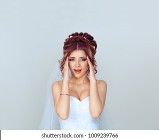 Stressed Screaming Spouse. Portrait Of A Young Woman Girl In Wedding Dress Having Stress A Headache, Migraine, Closeup Isolated Light Blue Background