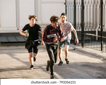 Stressed Smart Geek Running Away From Street Gang Thugs. Teenage Bullying. Chase Concept