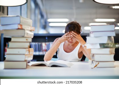 Stressed Student Of High School Sitting At The Library Desk, Tired And Bored To Study Asian Student Girl Preparing To The Exams, Female Student With Pile Of Books Study Hard For Exam In High School