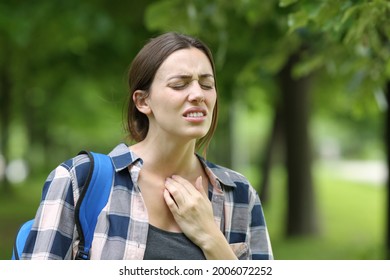 Stressed Student Suffering Throat Ache Walking In A Campus Or Park