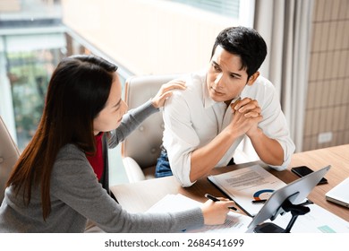 Stressed team with problem no solution at meeting, partners holding heads in hands depressed by failure bad news, feeling desperate about company bankruptcy or financial crisis.