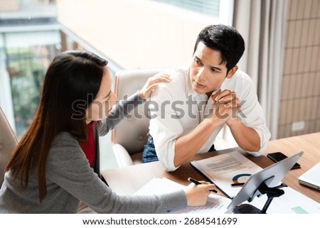 Stressed  team with problem no solution at meeting, partners holding heads in hands depressed by failure bad news, feeling desperate about company bankruptcy or financial crisis.