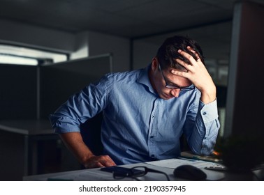 Stressed, tired business man suffering from headache, working late night in the office. Worried male entrepreneur thinking about problems and project deadline feeling burnout, distress and exhausted
