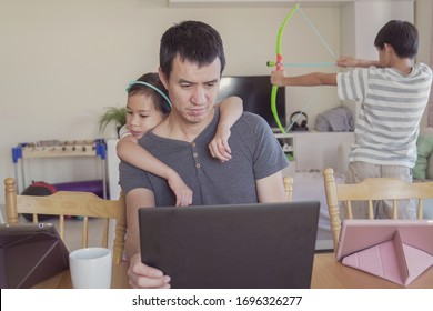 Stressed And Tired Parent Working From Home With Children. Homeschooling, Stay Home, Lockdown, Social Distancing During Covid-19 Coronavirus , Freelance Job Concept