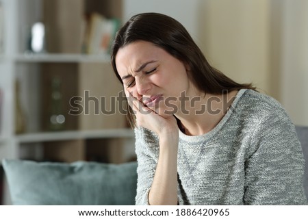 Stressed woman complaining suffering toothache sitting on a couch at home Stock photo © 