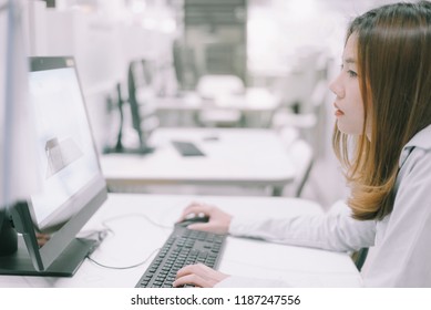 Stressed woman with computer at work,portrait of a businesswoman sitting on her workplace in the office, typing, looking at pc screen. - Shutterstock ID 1187247556
