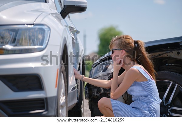 Stressed woman driver
sitting on street side shocked after car accident. Road safety and
insurance concept