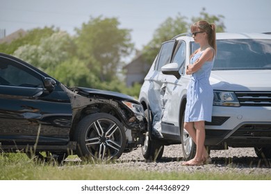 Stressed woman driver standing on street side shocked after car accident. Road safety and insurance concept