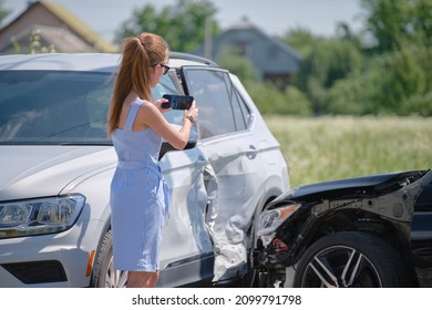 Stressed Woman Driver Taking Photo On Mobile Phone Camera After Vehicle Collision On Street Side For Emergency Service After Car Accident. Road Safety And Insurance Concept