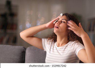 Stressed Woman Drying Sweat In A Warm Night Sitting On A Couch In The Living Room At Home