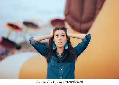 Stressed Woman Feeling Overwhelmed In Amusement Park. Unhappy Party Host Suffering From A Migraine From Loud Noise
