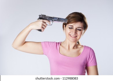Stressed woman with a gun pointing to his head