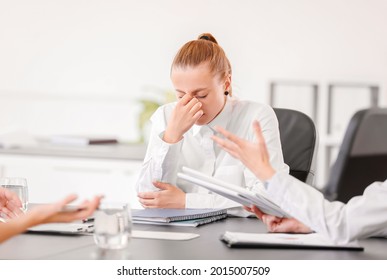 Stressed Woman With Headache And Noisy People In Office