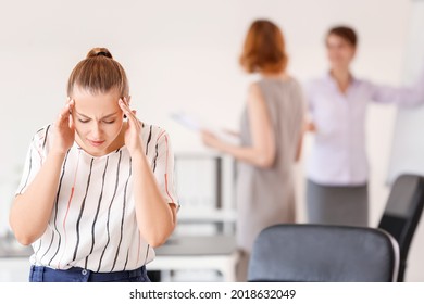 Stressed Woman With Headache And Noisy People In Office