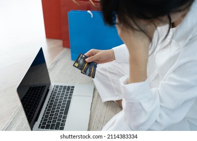 Stressed Woman Holding A Credit Card After Shopping. No Money To Pay Off Credit Card Debt.