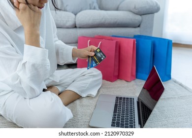 Stressed Woman Holding A Credit Card After Shopping. No Money To Pay Off Credit Card Debt.