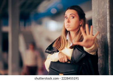
Stressed Woman Holding her Purse Pushing a Thief Away. Fearful woman feeling in danger setting personal boundaries 
 - Shutterstock ID 2228455191