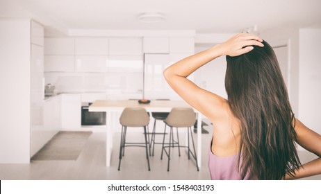 Stressed Woman Looking At Her Kitchen Apartment For Spring Cleaning Or Confused House Remodeling Renovating Home Interior Design. Choosing Condo Finishes In New Real Estate Project.