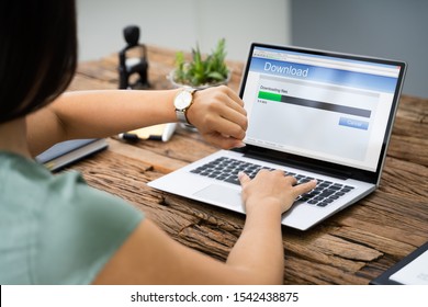 Stressed Woman Looking At Slow Download Speed On Laptop Screen