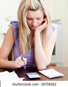 Stressed Woman Paying Her Bills In A Living-room