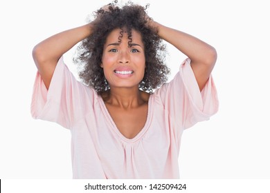 Stressed woman pulling her hair on white background