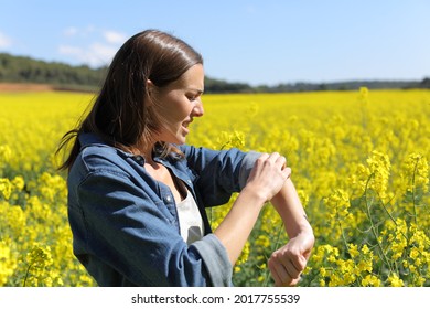 Stressed Woman Scratching Arm In A Field On Summer