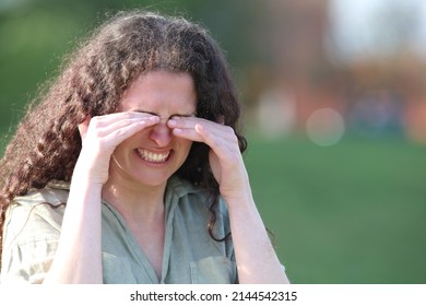 Stressed Woman Scratching Itchy Eyes Walking In A Park