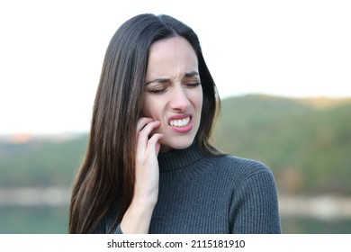 Stressed Woman Scratching Itchy Face In Winter In Nature