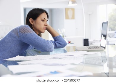 Stressed Woman Working At Laptop In Home Office