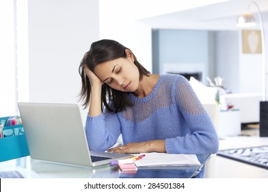 Stressed Woman Working At Laptop In Home Office