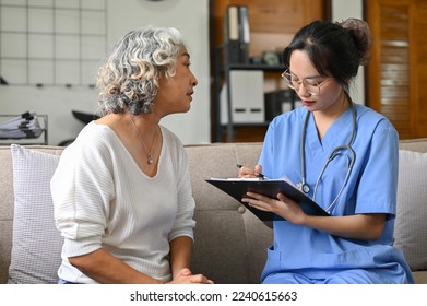 Stressed and worried Asian elderly female patient discussing medical checkup's result with her doctor in the hospital office. - Powered by Shutterstock
