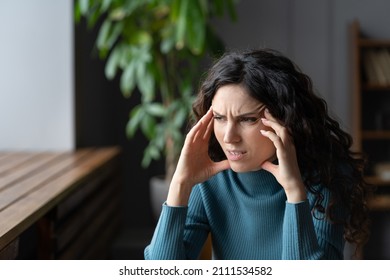 Stressed Worried Young Woman Suffering From Anxiety Headache, Feeling Dull Pain Or Pressure Around Forehead. Concerned Troubled Female Having Anxious Thoughts, Thinking About Problem Or Life Situation