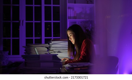 Stressed young asian woman sitting work overtime doing late time business at office in night on desk, Exhausted businesswoman concept. - Powered by Shutterstock