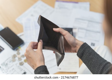 stressed young asian woman trying to find money to pay credit card debt. - Shutterstock ID 2174676877