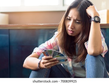 Stressed Young Asian Woman Trying To Find Money To Pay Credit Card Debt.