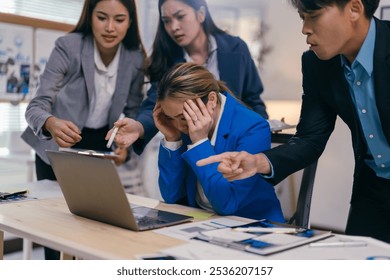 Stressed young businesswoman blamed by coworkers in office, feeling overwhelmed, upset, and burnt out. Dealing with conflict, harassment, and pressure at work - Powered by Shutterstock