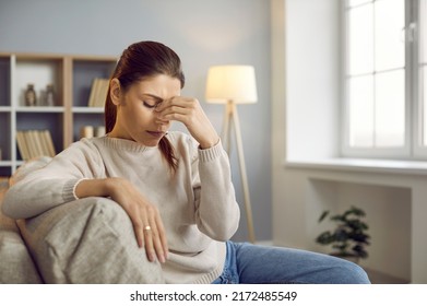 Stressed Young Caucasian Woman Massage Eyes Suffer From Headache Or Migraine At Home. Unhealthy Girl Struggle With Dizziness Or Blurry Vision, Relieve Tension. Medicine And Healthcare Concept.